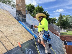 A contractor working on a roofing project from June 2024