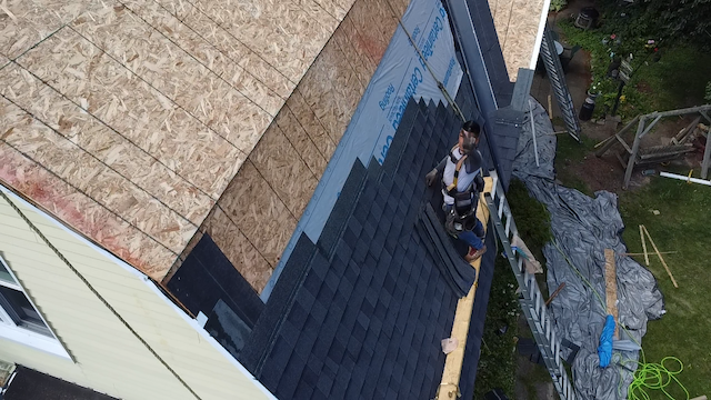 Contractor doing a peace sign while completing a roofing project - July 2024