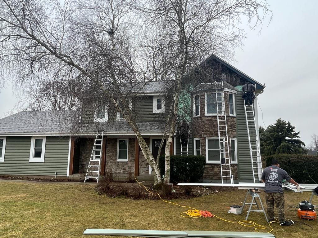 Upper level siding around window by Semper Fi