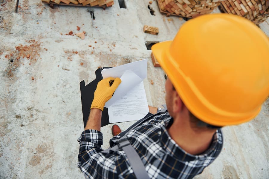 Roofing contractor providing written inspection report to homeowner